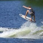 A man is riding a surfboard.