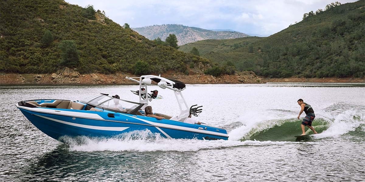 Supreme S238 action wake surfing with mountains in background