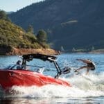Red Supreme ZS232 wake surfing across lake