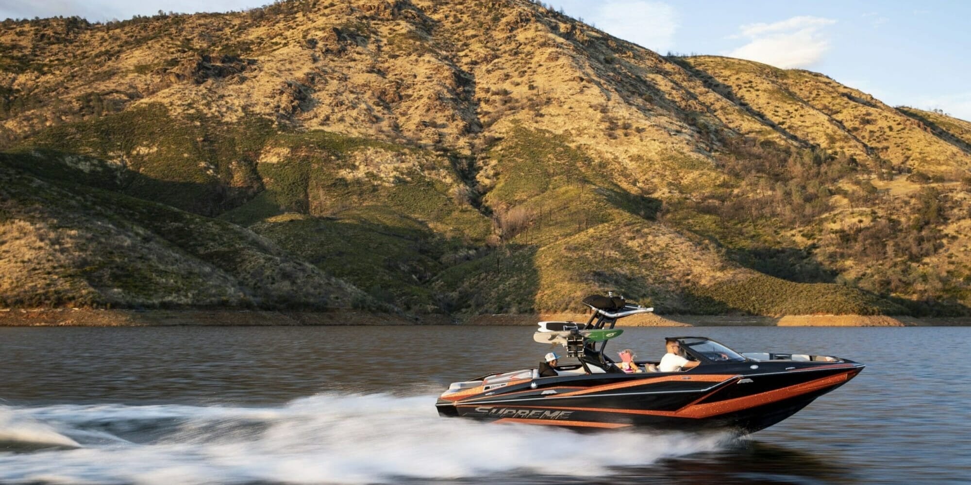 A man is riding a Supreme jet ski on a body of water.