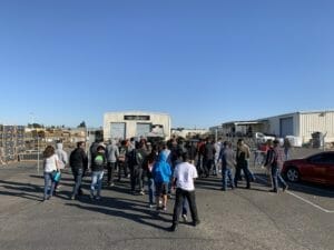 A group of people standing in a parking lot near Supreme Boats.