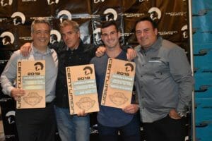 Four men are posing for a picture holding Supreme signs.