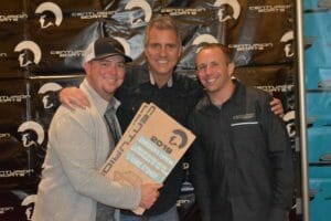 Three men posing for a picture with a Supreme sign.