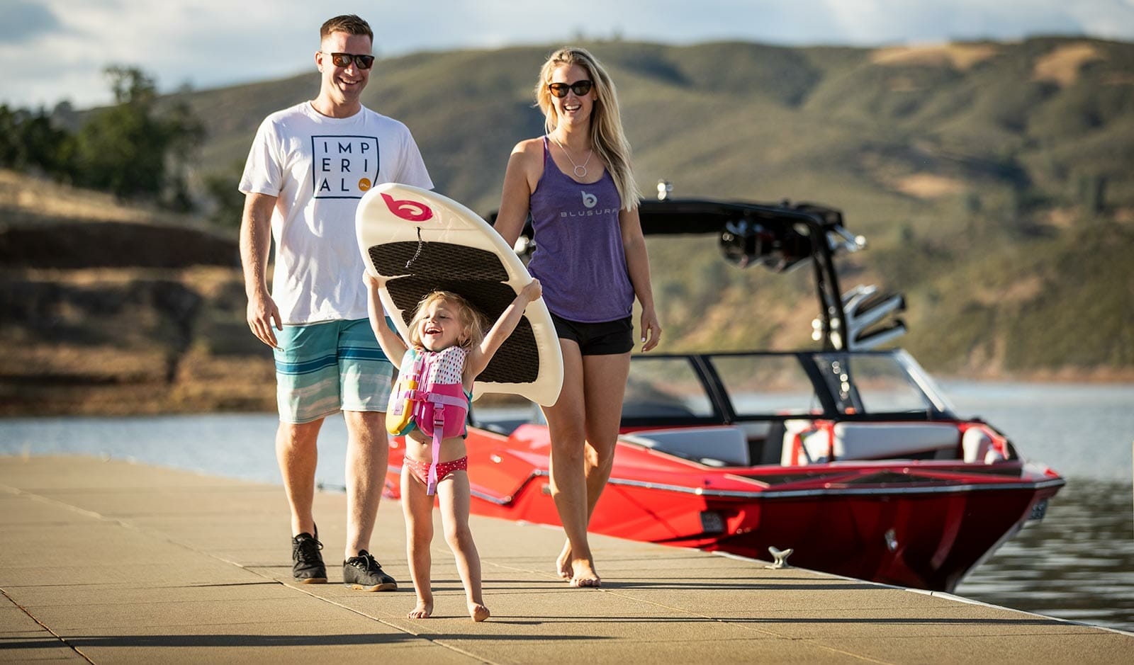 A family with a child on a dock.