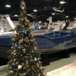 A Supreme Boats at a boat show displaying a christmas tree.