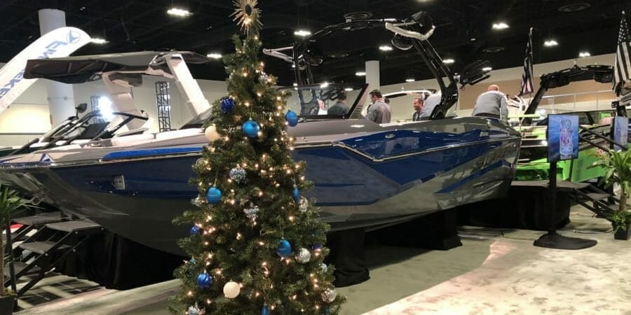 A Supreme Boats at a boat show displaying a christmas tree.