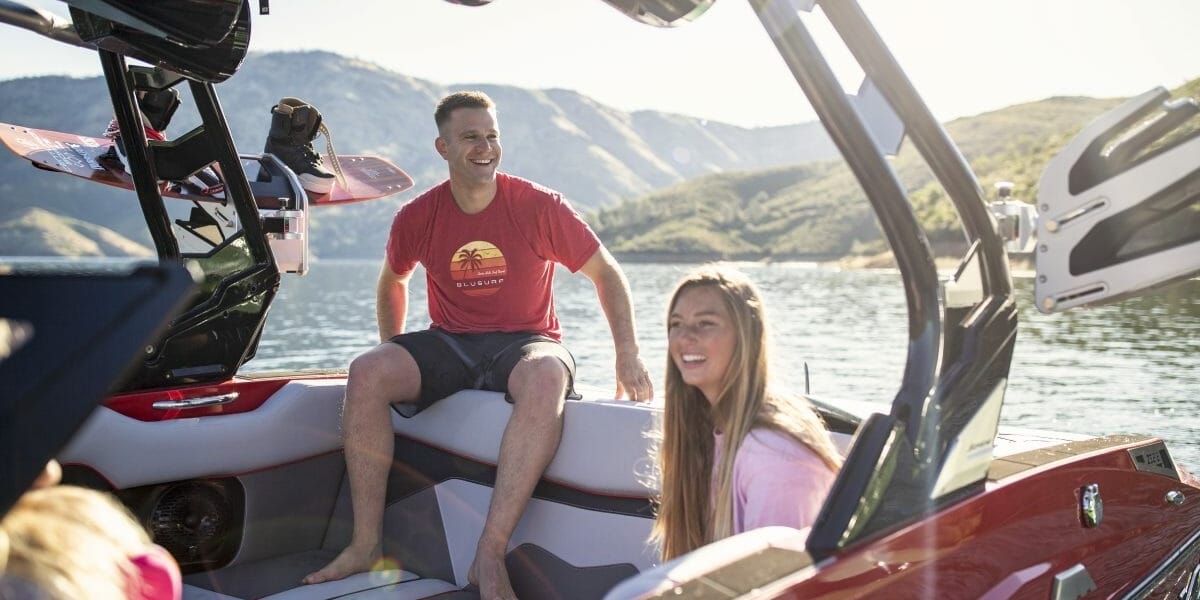 A group of people sitting in the back of a Supreme boat.