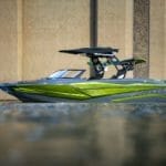 A Supreme wakeboard boat is floating in the water.