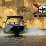 A Supreme boat with a skull and crossbones in the water.