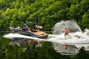 A man is riding a Supreme jet ski on a lake.