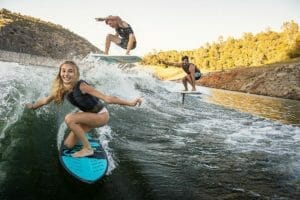 Three surfers on one wake