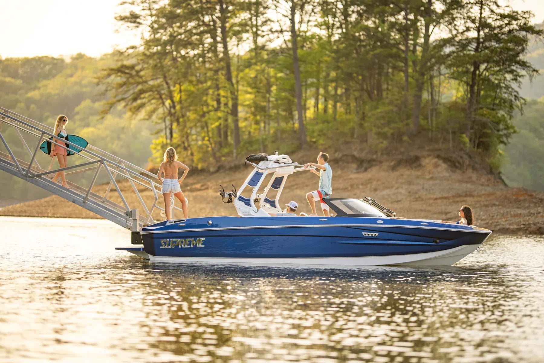 Woman walking down boat ramp to a Supreme boat