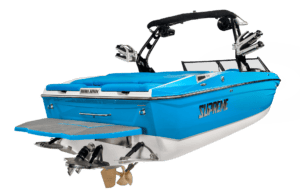 A blue and white Supreme Boats S240 wakeboarding boat with a sleek design, featuring a swim platform, wakeboard racks, and a black tower with speakers.