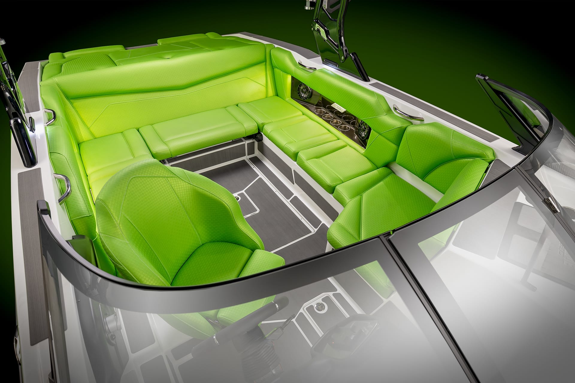 A boat's interior featuring bright green, cushioned seating with a sleek design and multiple cup holders against a dark green background, exemplifying the luxurious comfort of the Supreme S220.