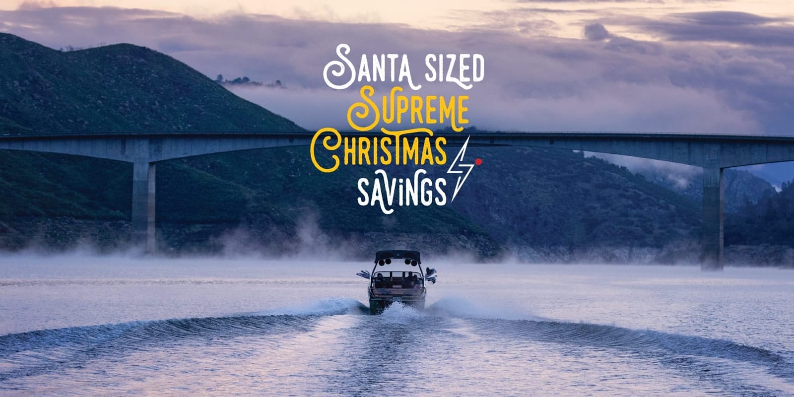 A boat on the water with a bridge in the background, showcasing Santa-Sized savings during this Supreme Christmas season.