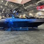 At the Portland Boat Show, a black and silver boat with "Supreme" branding, part of the esteemed Supreme Family, stands out on display.